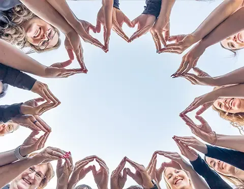 Group creating shape with hands